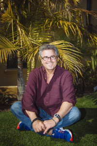 Actor Christopher Knight seated comfortably on his new artificial lawn in Hermosa Beach (photo by David Walter Banks)